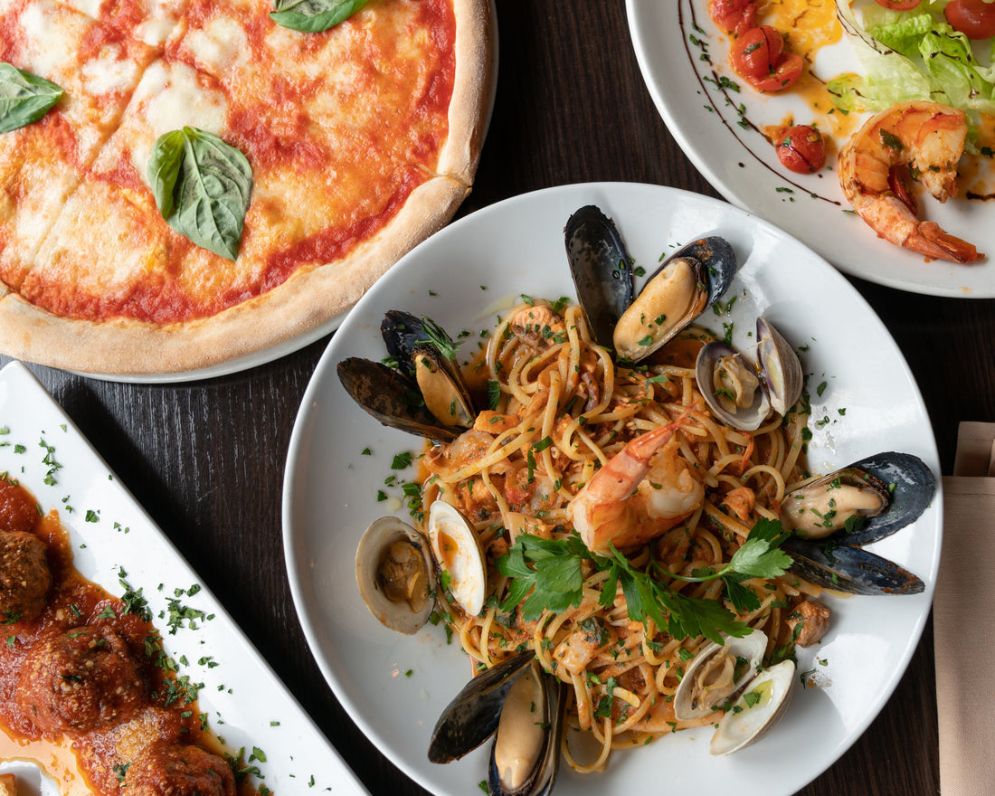 Shellfish and pizza on a table on plates