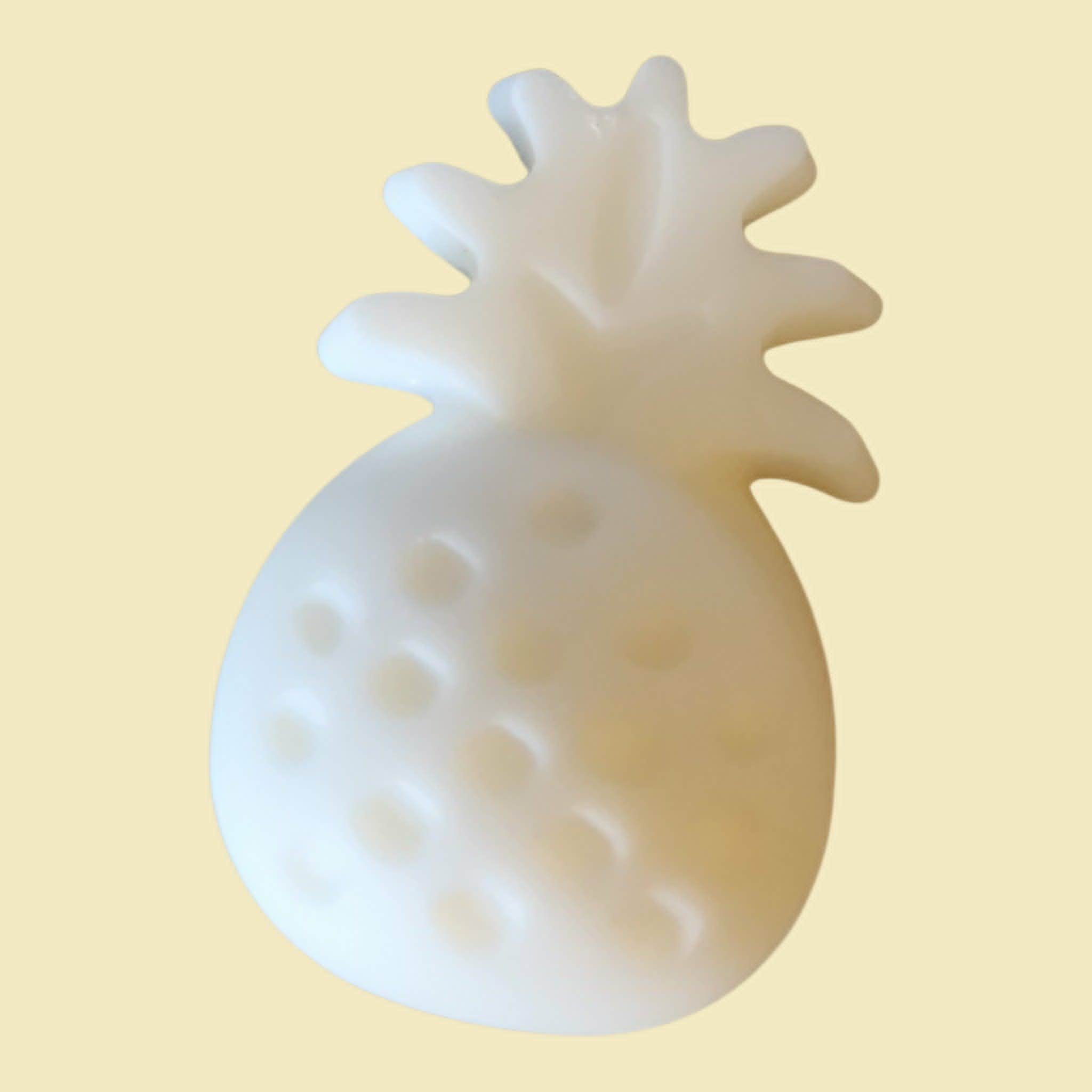 White pineapple-shaped object on a beige background