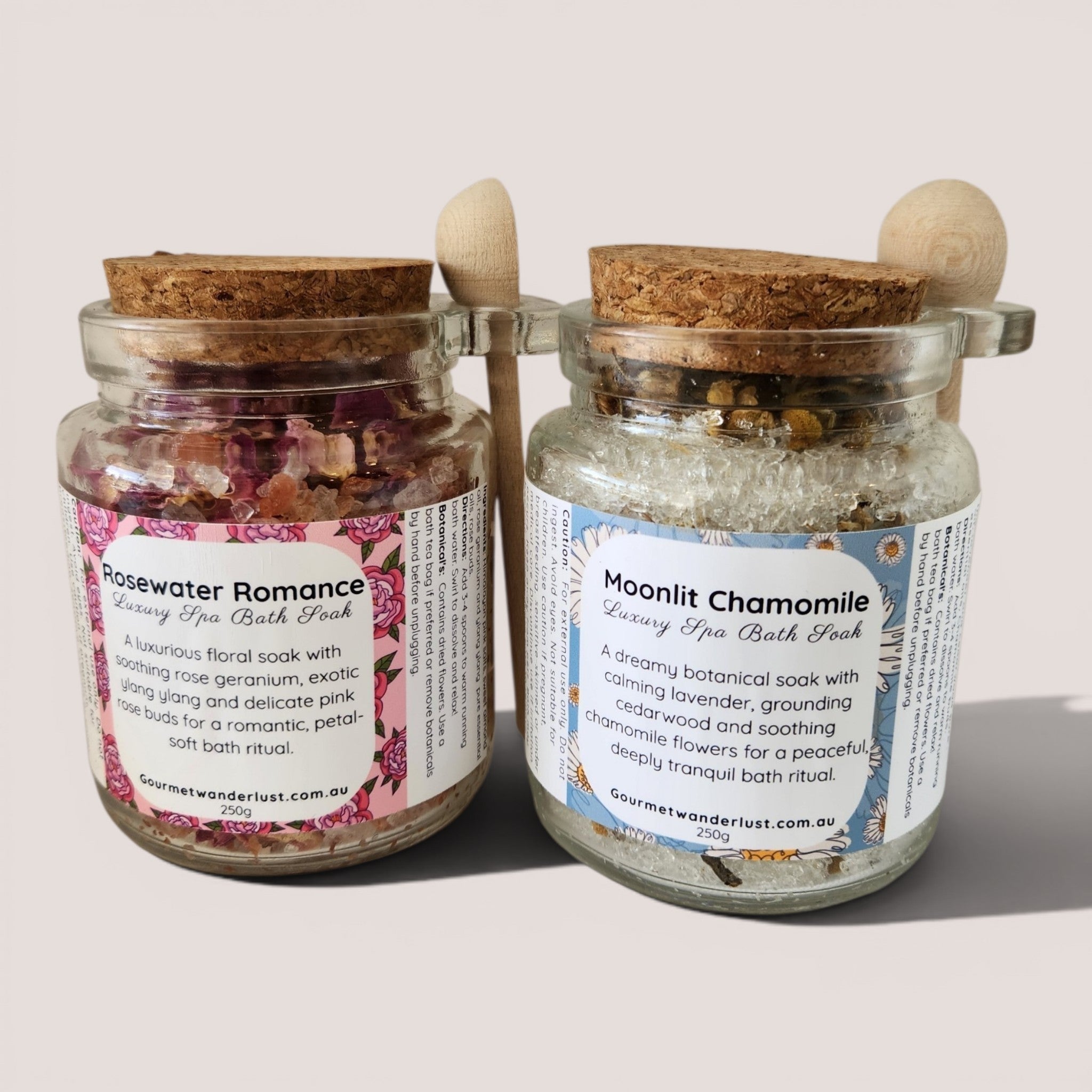 Two glass jars with cork lids containing bath products on a light background