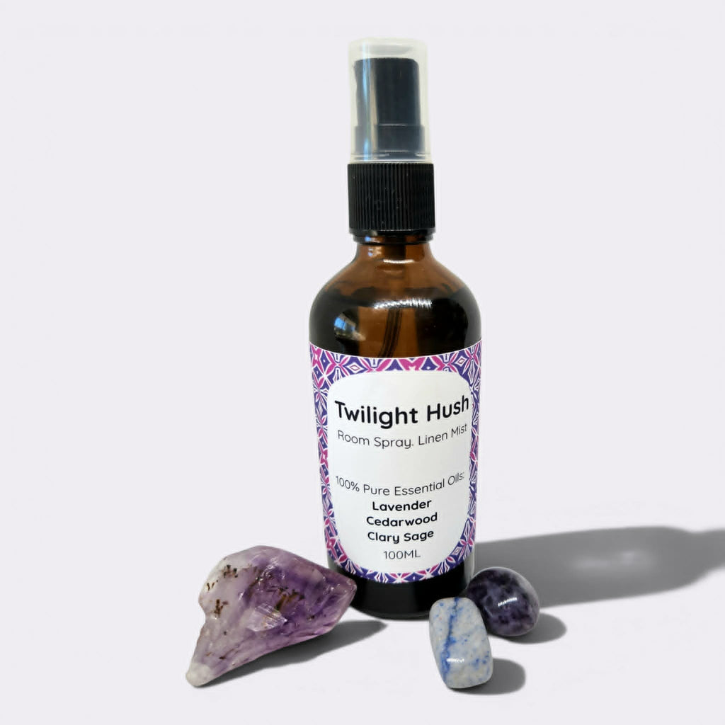 Bottle of Twilight Hush room spray with crystals on a white background