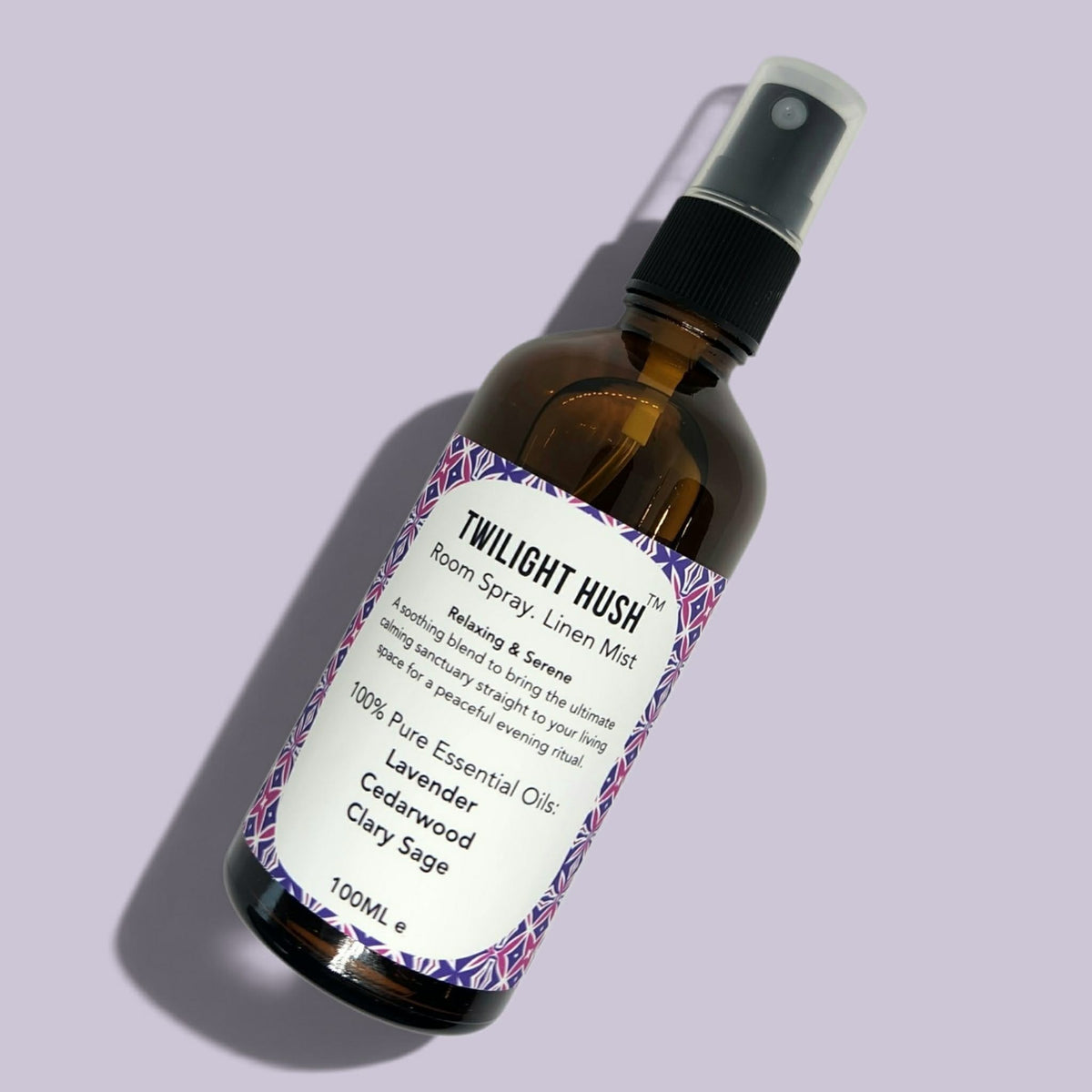 Glass Amber bottle of Twilight Hush in a photoshoot with lilac background