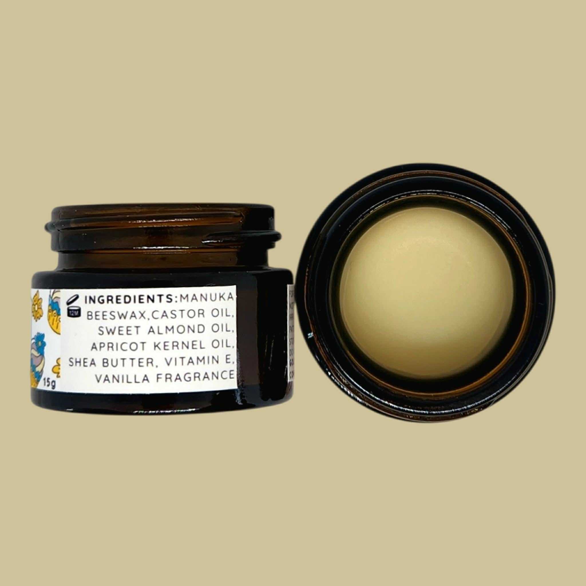An open dark amber cosmetic jar with a white ingredient label, shown beside its open lid on a solid beige background. The inside of the lid reveals a pale cream-colored balm or lip product.